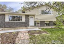 Charming two-story home with a brick exterior, well-maintained lawn, and inviting front entrance at 1352 S Terry St, Longmont, CO 80501