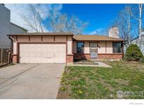 Charming ranch-style house featuring a two-car garage and a well-maintained front yard at 17580 E Temple Dr, Aurora, CO 80015