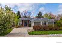 Charming single-story home featuring a well-manicured lawn and a welcoming brick-accented entrance at 2330 Sandpiper Dr, Lafayette, CO 80026