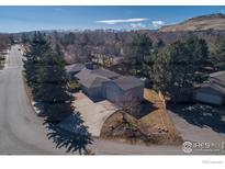 Sprawling single-Gathering home featuring mature trees, a spacious driveway, and mountain views at 2605 Crabapple Ct, Golden, CO 80401