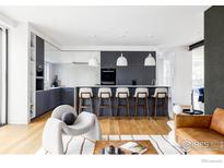 Modern kitchen featuring a large island with seating, sleek cabinetry, and stylish pendant lighting at 2670 6Th St, Boulder, CO 80304