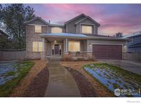 Charming two-story home featuring a covered porch, brick accents, and a well-maintained front yard at 2834 Blue Jay Way, Lafayette, CO 80026