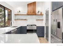 Modern kitchen with sleek cabinetry, stainless steel appliances, and ample countertop space at 3809 Howe Ct, Boulder, CO 80301
