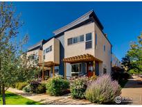 Modern townhomes with individual covered front porches and a lush landscaped walkway at 4661 14Th St, Boulder, CO 80304
