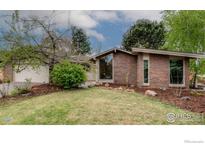 Charming brick home with manicured front yard and mature landscaping providing great curb appeal at 4760 Harrison Ave, Boulder, CO 80303