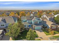 Inviting two-story home with a lush, well-manicured lawn and charming curb appeal at 6317 Ruby Hill Dr, Frederick, CO 80516