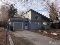 Charming home with a two-car garage and a unique, eye-catching, round window on the second floor at 843 Sumner St, Longmont, CO 80501
