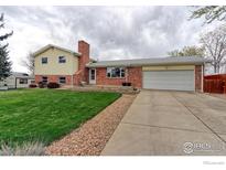 Charming two-story home with brick accents, an attached two-car garage, and well-maintained lawn at 10538 Quivas St, Northglenn, CO 80234