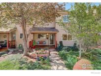 Charming townhome with a welcoming porch, garden, and lush landscaping at 1460 Quince Ave # 102, Boulder, CO 80304