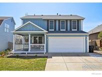 Charming two-story home with a covered porch and a well-maintained lawn in a Gathering-friendly neighborhood at 21112 E 45Th Ave, Denver, CO 80249