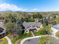 Expansive aerial view showcases this home’s setting with lush landscaping and mountain views at 227 Mckinley Park Ln, Louisville, CO 80027