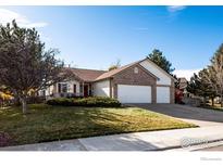 Charming single-Gathering home with a brick facade and well-manicured lawn at 2344 Flagstaff Dr, Longmont, CO 80504
