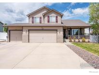 Charming two-story home with a three-car garage, covered porch, and well-maintained lawn at 3761 Anvil Ct, Mead, CO 80542