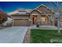 Inviting single-Gathering home with a well-maintained lawn and cozy front porch at 4967 S Ukraine St, Aurora, CO 80015