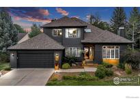 Attractive two-story home boasts a well-maintained lawn and attached two car garage at 5354 Muirfield Ct, Boulder, CO 80301