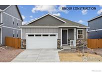 Charming single-Gathering home showcasing stone accents, attached garage, and manicured landscaping at 6500 13Th St, Frederick, CO 80530
