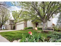 Charming two-story home with lush front yard, mature trees, and inviting bench at 6646 Bean Mountain Ln, Boulder, CO 80301