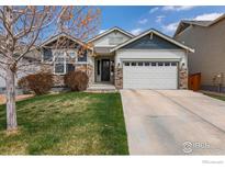 Charming home featuring a two-car garage and manicured lawn in a residential neighborhood at 850 Prairiestar Dr, Berthoud, CO 80513