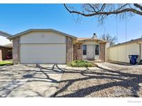 Charming brick home featuring a two-car garage and a well-maintained front yard at 9655 W 105Th Way, Broomfield, CO 80021