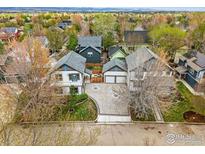 An aerial view of the neighborhood featuring well-manicured lawns, mature trees, and beautiful home exteriors at 1230 Tyler Pl, Erie, CO 80516