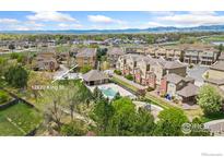 Aerial view of a townhouse community featuring a swimming pool, playground, and well-maintained landscaping at 12820 King St, Broomfield, CO 80020