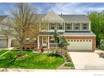 Charming two-story home with brick facade, lush lawn and mature tree in a desirable neighborhood at 2822 Flint Ct, Superior, CO 80027