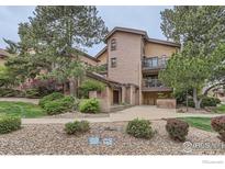 Attractive exterior of building with mature trees and a landscaped entrance at 4475 Laguna Pl # 206, Boulder, CO 80303