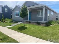 Charming single-Gathering home featuring a well-manicured lawn and inviting front porch at 4672 Clear Creek Dr, Longmont, CO 80504