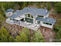 Stunning contemporary home with expansive deck, floor-to-ceiling windows and mountain views at 50 Wildwood Ln, Boulder, CO 80304