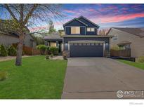 Charming two-story home featuring a well-manicured lawn and attached two-car garage at 5822 Shenandoah Ave, Firestone, CO 80504