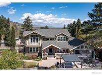 Stunning exterior of a multi-story home featuring a stone foundation, covered entrance, and a large outdoor living space at 709 Baseline Rd, Boulder, CO 80302