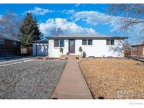 Charming, white, one-story home with well-maintained landscaping and a quaint front walkway at 8861 Hastings Way, Westminster, CO 80031