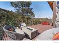 Inviting outdoor deck features a fire pit and comfortable seating, perfect for enjoying the surrounding nature at 1127 Valley Ln, Boulder, CO 80302