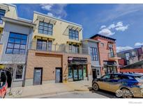 Modern townhouse featuring brick and siding accents with large windows and awnings on a sunny day at 1200 Yarmouth Ave # 238, Boulder, CO 80304