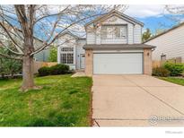 Charming two-story home with a well-maintained lawn, brick accents and attached two-car garage at 1842 Reliance Cir, Superior, CO 80027