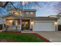 Charming two-story home featuring a well-manicured lawn, covered porch, and an attached two-car garage at 2085 E 127Th Pl, Thornton, CO 80241