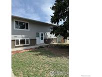 Two-story exterior with large front yard and mature tree providing shade at 2221 E 84Th Ave, Denver, CO 80229