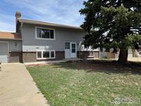 Charming home featuring a well-manicured lawn and mature tree, creating a welcoming and picturesque curb appeal at 2221 E 84Th Ave, Denver, CO 80229