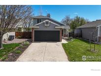 Charming home featuring a two-car garage, a well-manicured lawn, and tasteful landscaping around the front walkway at 2330 Redwood Ave, Lafayette, CO 80026