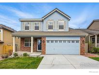 Charming two-story home featuring a brick facade and a blue exterior at 2926 Castle Peak Ave, Superior, CO 80027
