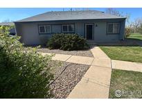 Charming home with tidy landscaping, including a concrete walkway and well-maintained bushes at 4350 Monroe Dr, Boulder, CO 80303
