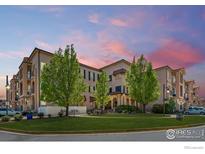 Exterior shot of building featuring trees and a lawn area with a pink and purple sunset sky at 4500 Baseline Rd # 3302, Boulder, CO 80303