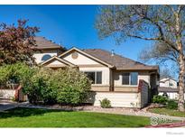 Charming home featuring well-maintained landscaping, mature trees, and a welcoming facade with neutral tones and abundant natural light at 650 Ridgeview Dr, Louisville, CO 80027