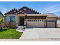 Charming two-story home with landscaped front yard and attached two-car garage at 725 Canyonlands St, Berthoud, CO 80513