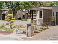 Contemporary home with unique landscaping, a modern mailbox, and architectural wood and stucco elements at 7323 Old Post Rd, Boulder, CO 80301