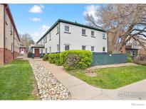 Charming two-story building with a well-maintained lawn and landscaping at 961 16Th St # 4, Boulder, CO 80302