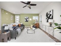 Inviting living room with modern decor, ceiling fan, and lots of natural light at 10022 Reunion Pkwy, Commerce City, CO 80022