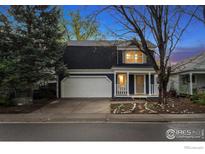 Charming two-story home with a well-maintained front yard and attached two-car garage at 1032 Pegasus Pl, Lafayette, CO 80026