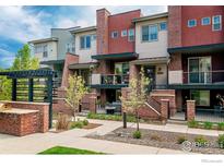 Charming townhomes featuring brick accents, private balconies, and landscaped grounds, perfect for modern living at 1069 Johnson Ln, Louisville, CO 80027
