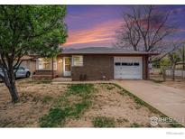 Charming brick home with attached garage and mature trees in a well-established neighborhood at 1153 Lincoln St, Longmont, CO 80501